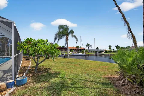 a view of a swimming pool with a chair and tables