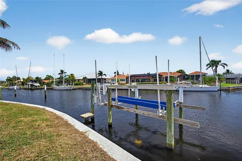 a room with lots of white furniture and water view