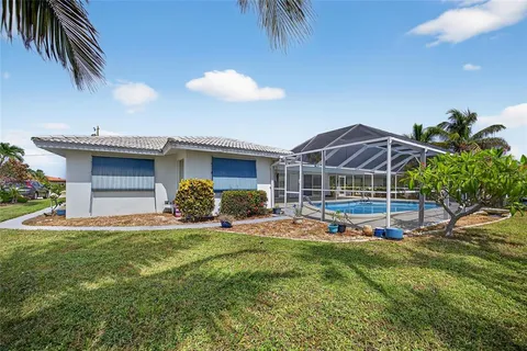 a view of a house with a backyard porch and sitting area