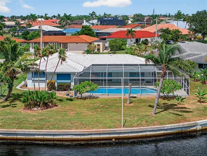 a view of a house with a yard and sitting area