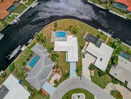 an aerial view of a house with a swimming pool