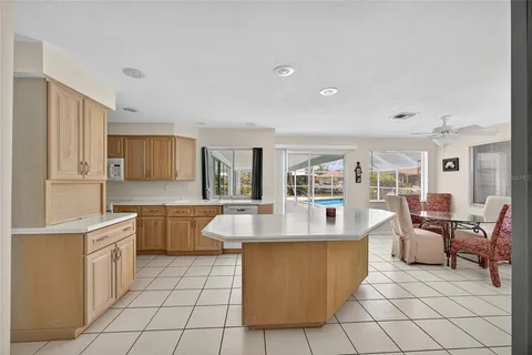 a kitchen with stainless steel appliances granite countertop a sink and a refrigerator