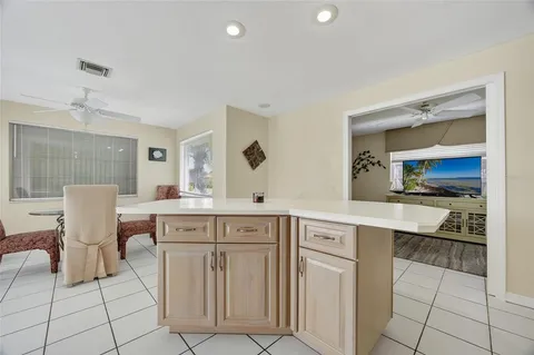 a kitchen with cabinets and chairs