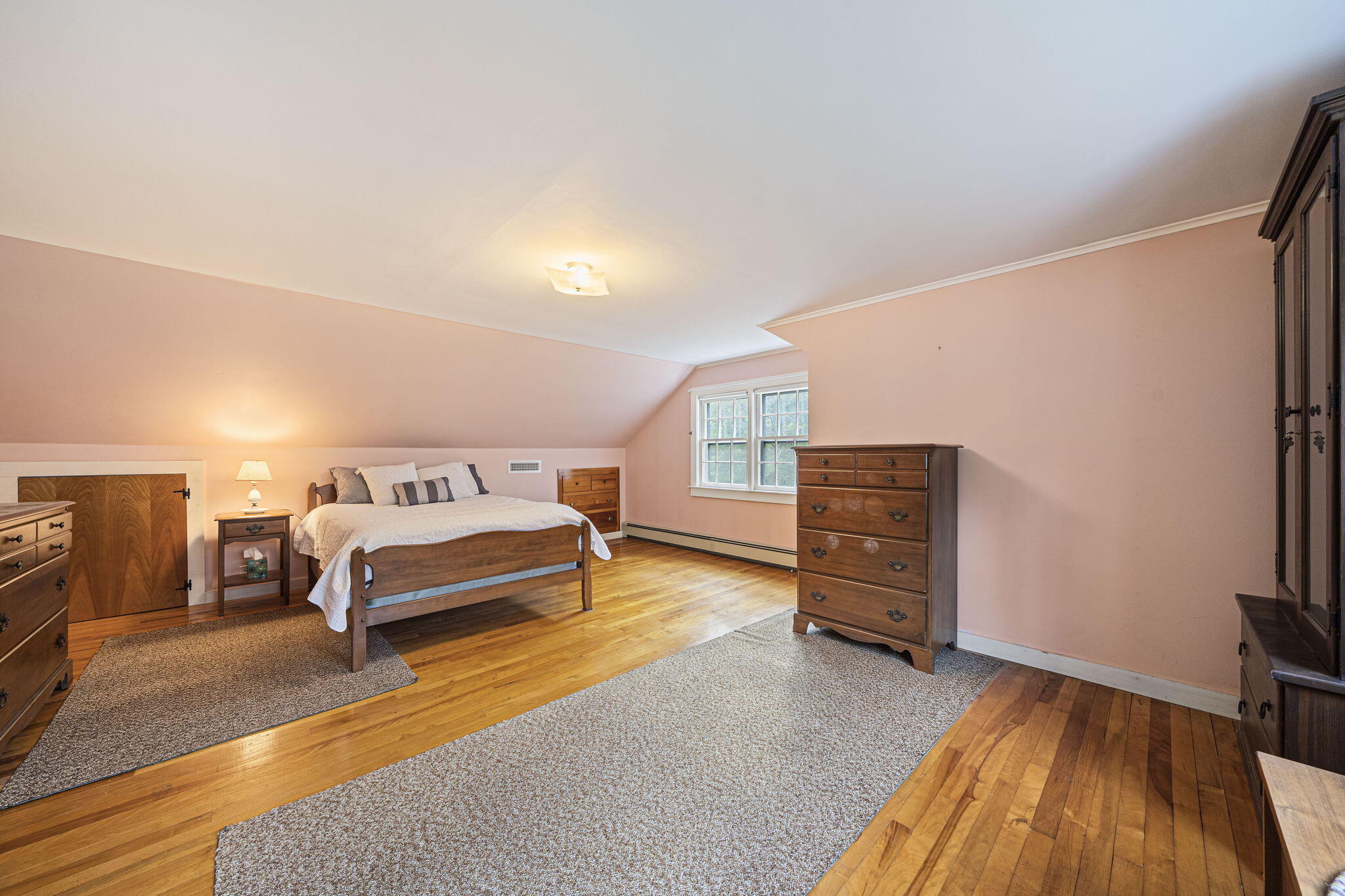606 County Road Pocasset, MA 02559 - Photo 25 of 36 a spacious bedroom with a bed and wooden floor