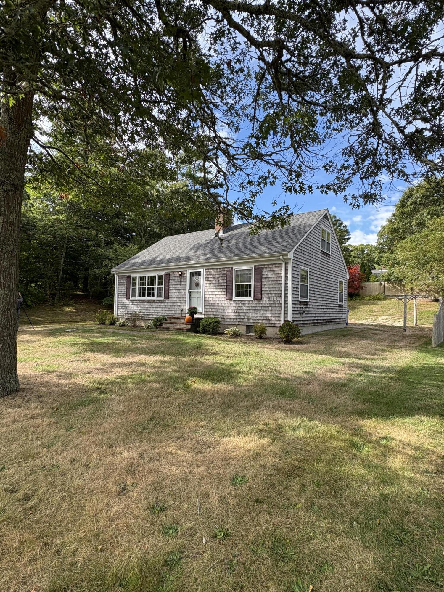606 County Road Pocasset, MA 02559 - Photo 28 of 36 a view of a house with a backyard