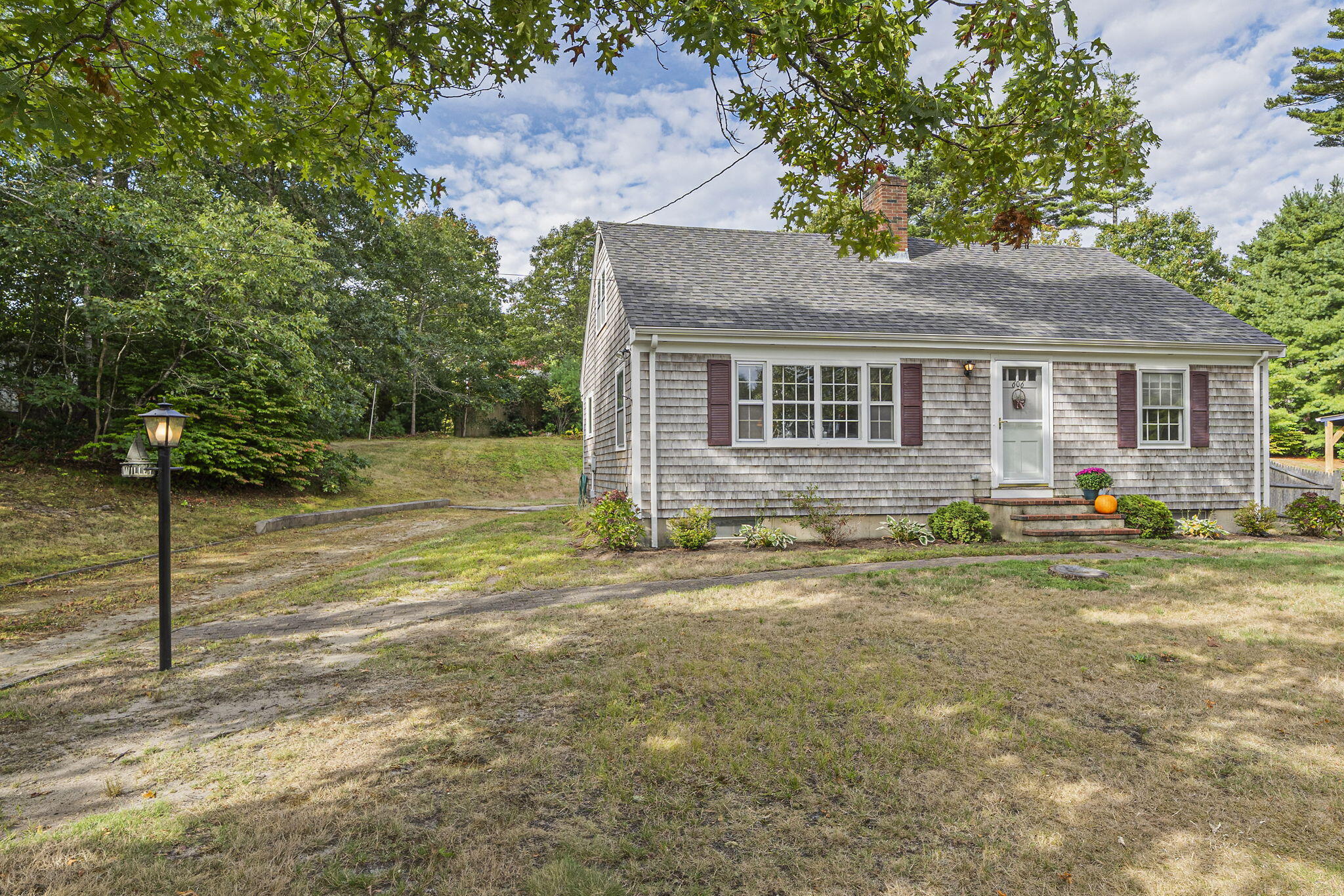 606 County Road Pocasset, MA 02559 - Photo 29 of 36 a front view of a house with garden