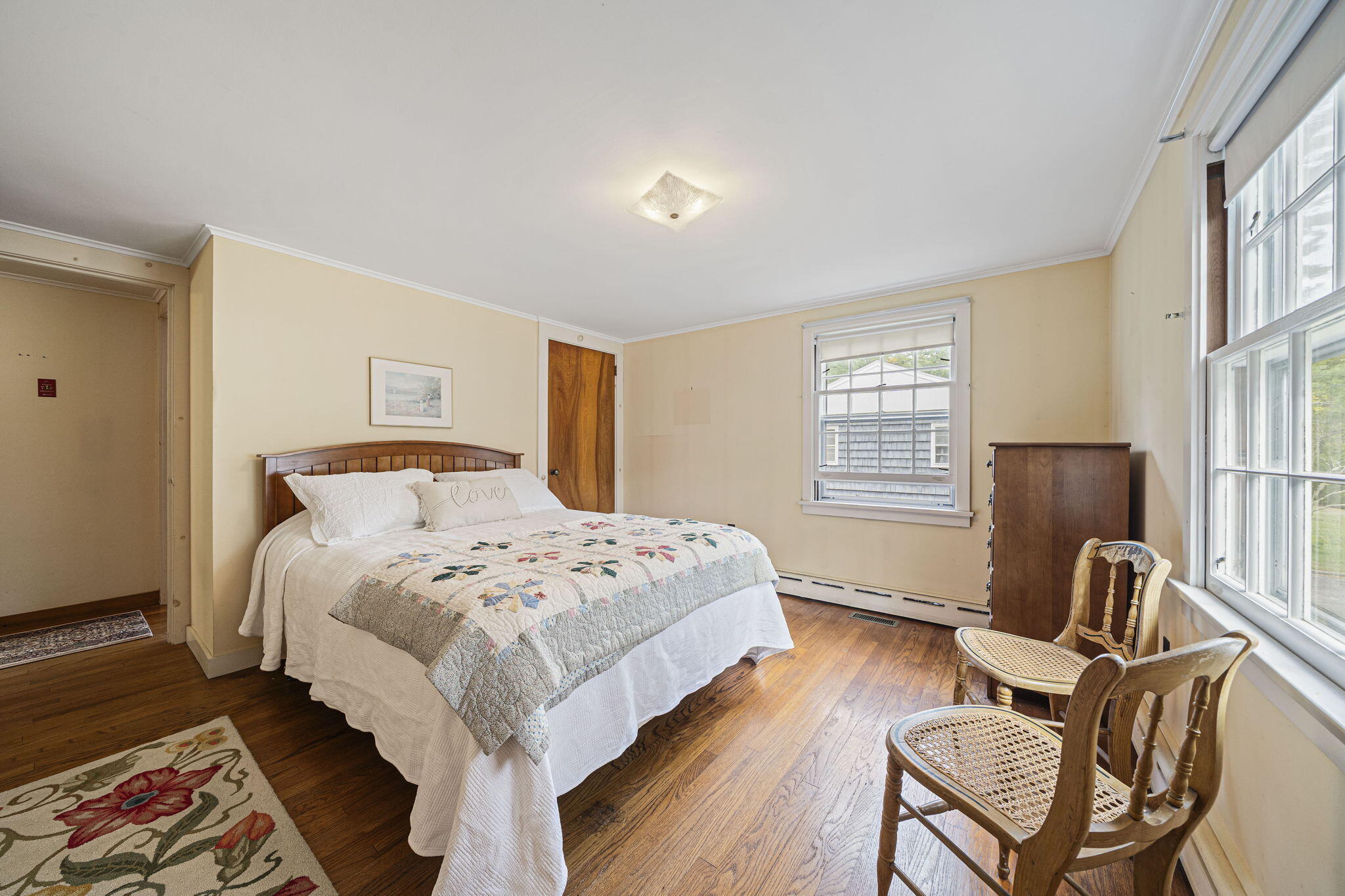 606 County Road Pocasset, MA 02559 - Photo 7 of 36 a bedroom with a bed a chair and wooden floor