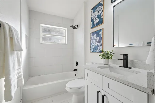 a bath room with a toilet a sink and a bath tub