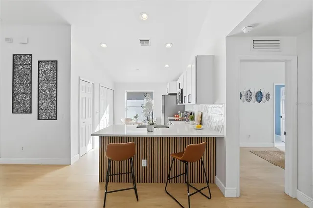 a kitchen with stainless steel appliances kitchen island granite countertop a sink and cabinets