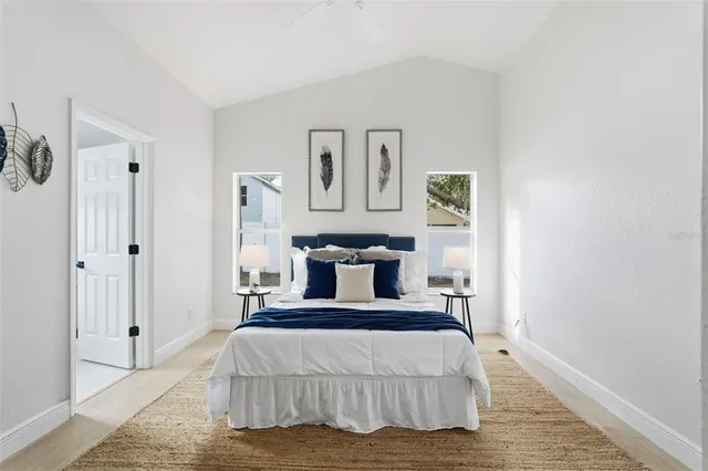 a bedroom with a bed and painting on the wall