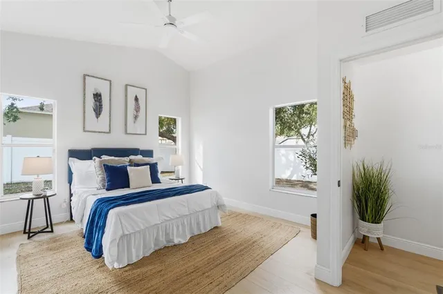 a bedroom with a bed and a potted plant