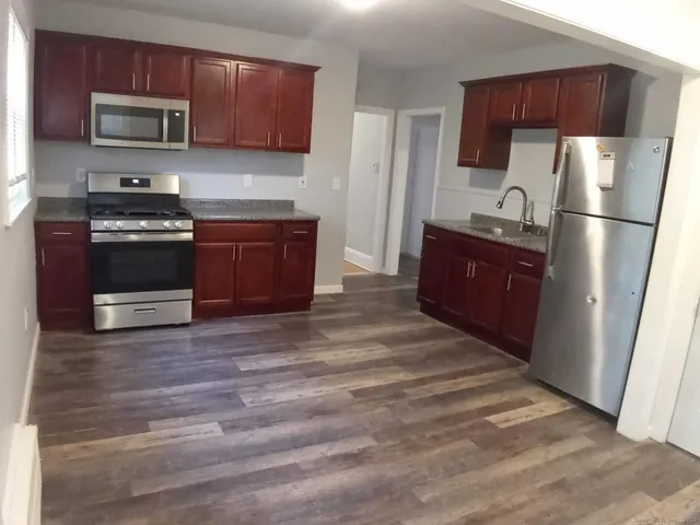 a kitchen with stainless steel appliances and wood cabinets