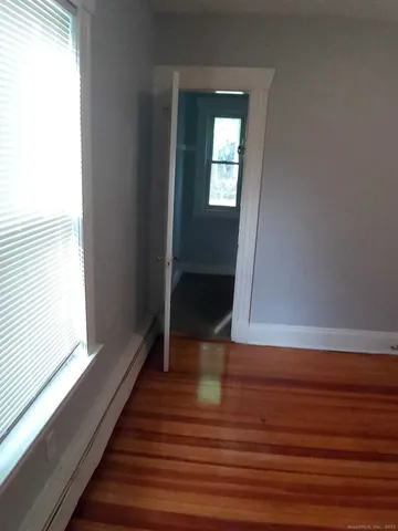 a view of a room with wooden floor and staircase