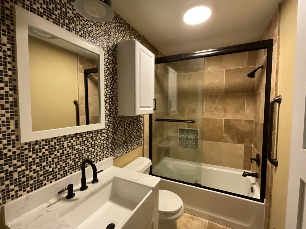 207 South George Street Victoria, TX 77901 - Photo 12 of 27 a bathroom with a sink mirror toilet and shower