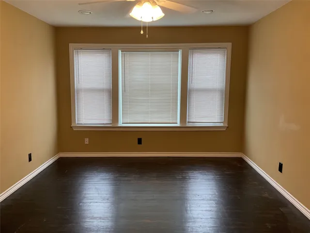 a view of room with window and hardwood floor