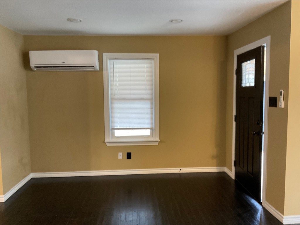 207 South George Street Victoria, TX 77901 - Photo 16 of 27 a view of an empty room with wooden floor and a window