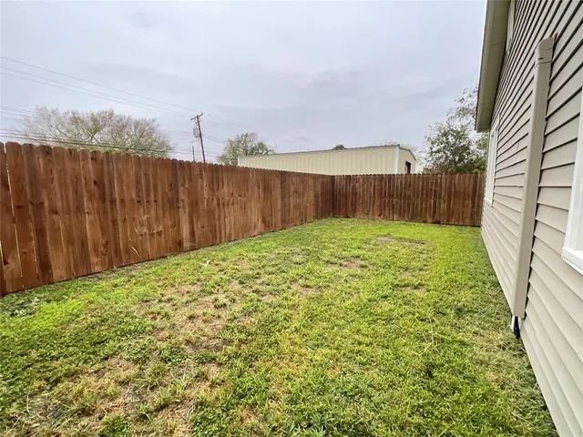 a view of a backyard with wooden floor and floor to ceiling window