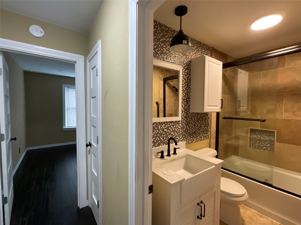 207 South George Street Victoria, TX 77901 - Photo 7 of 27 a bathroom with a sink a toilet and shower