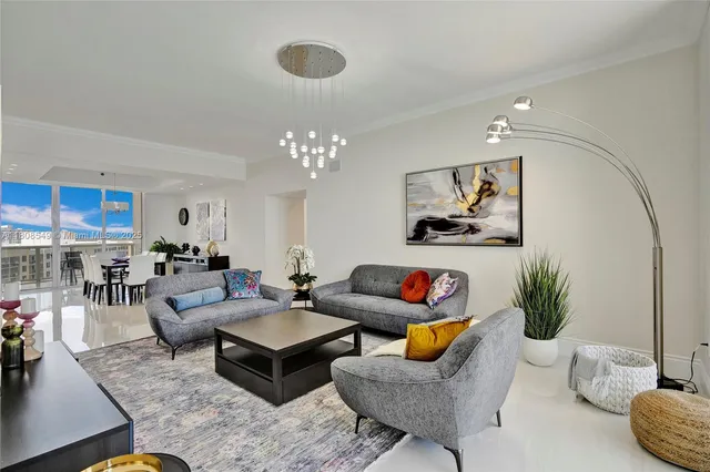 a living room with furniture and a chandelier