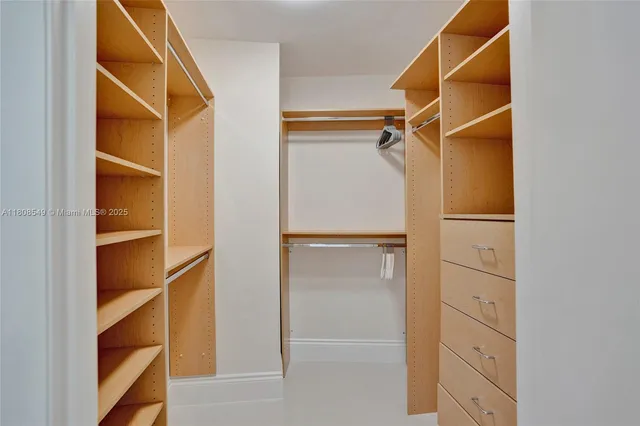 a view of walk in closet with empty racks