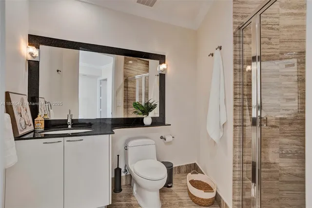 a bathroom with a toilet sink and shower