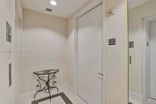 a view of staircase with railing and white walls