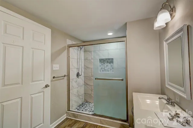 a bathroom with a shower and a sink