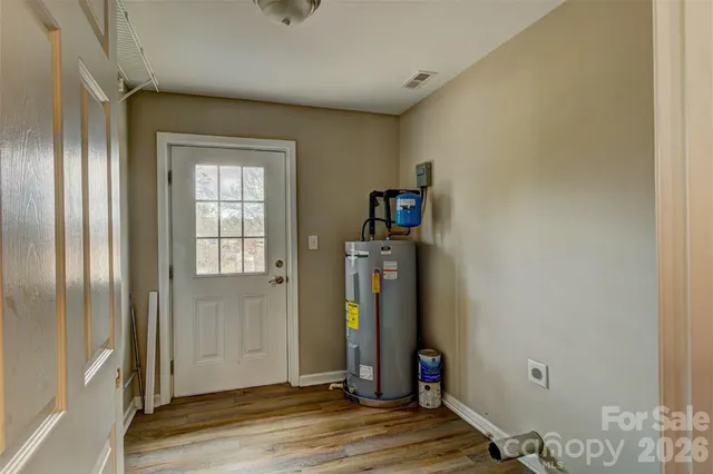 a view of a room with wooden floor