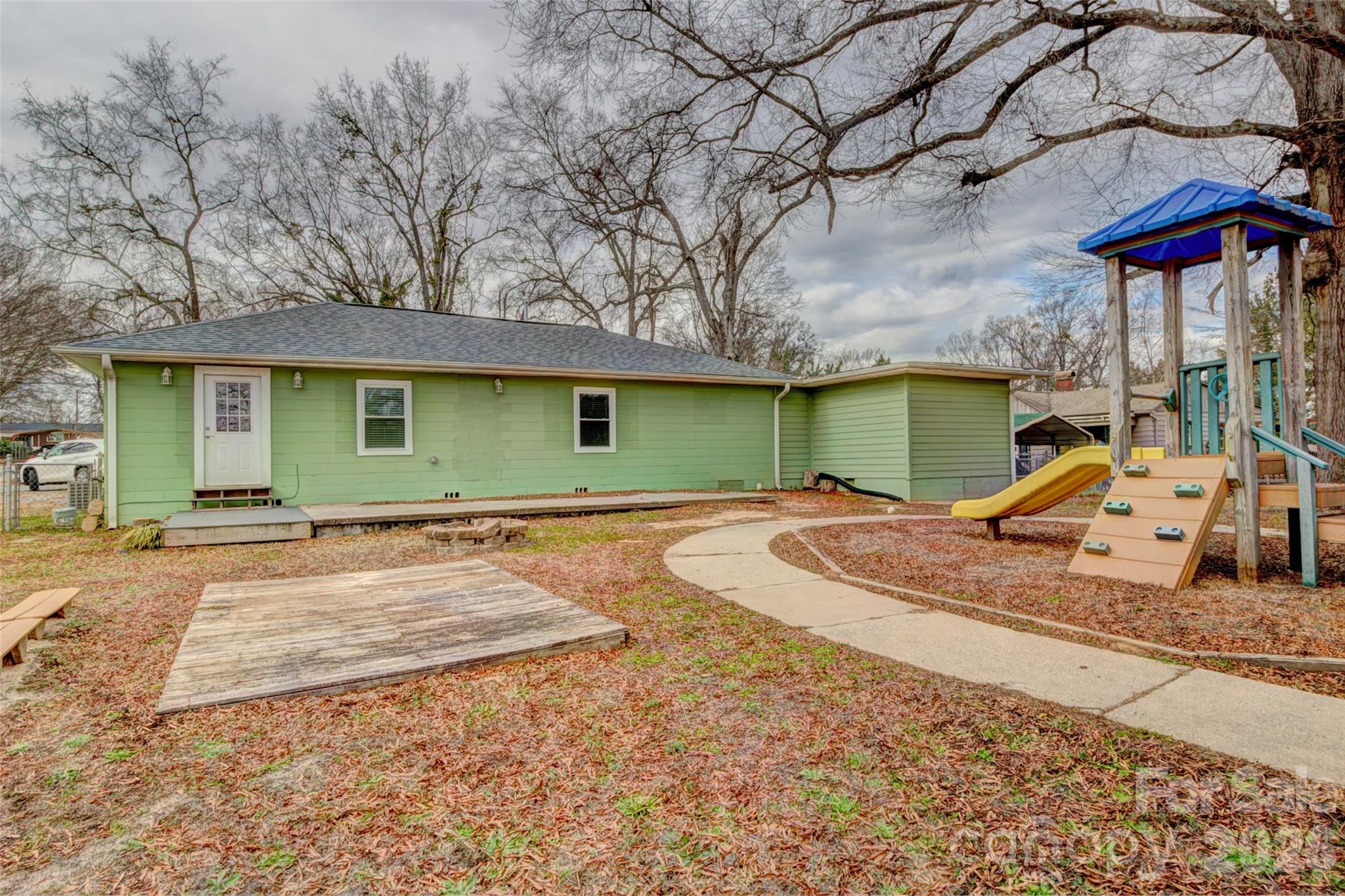 202 Ramsey Street Cherryville, NC 28021 - Photo 16 of 17 a view of a backyard with a patio and fire pit
