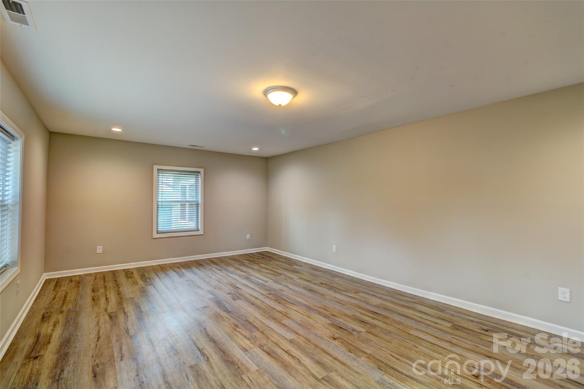 202 Ramsey Street Cherryville, NC 28021 - Photo 2 of 17 a view of an empty room with wooden floor and a window