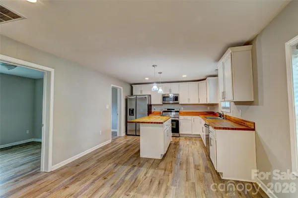 a kitchen with a refrigerator and a stove