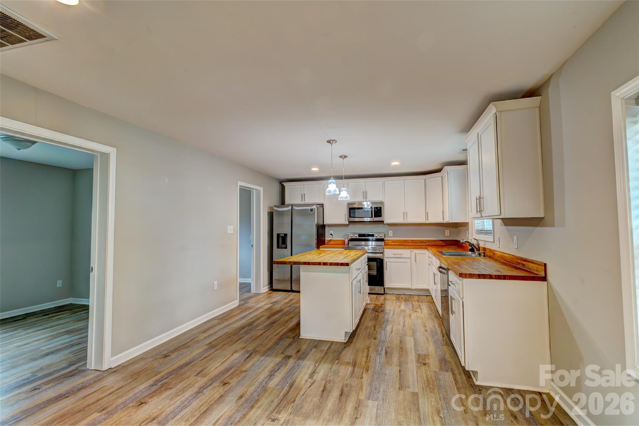 202 Ramsey Street Cherryville, NC 28021 - Photo 3 of 17 a kitchen with a refrigerator and a stove