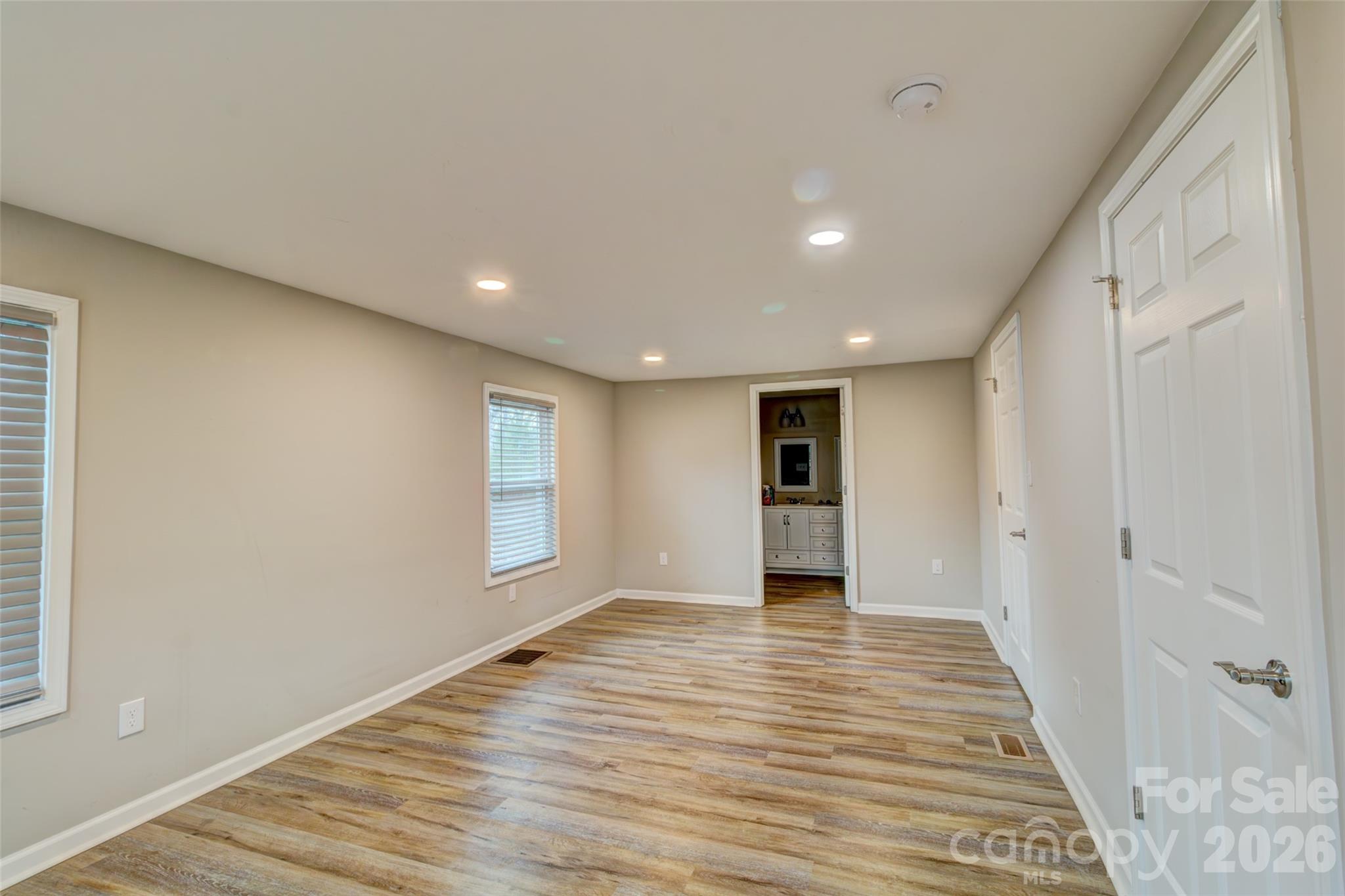 202 Ramsey Street Cherryville, NC 28021 - Photo 5 of 17 a view of an empty room with wooden floor and a window