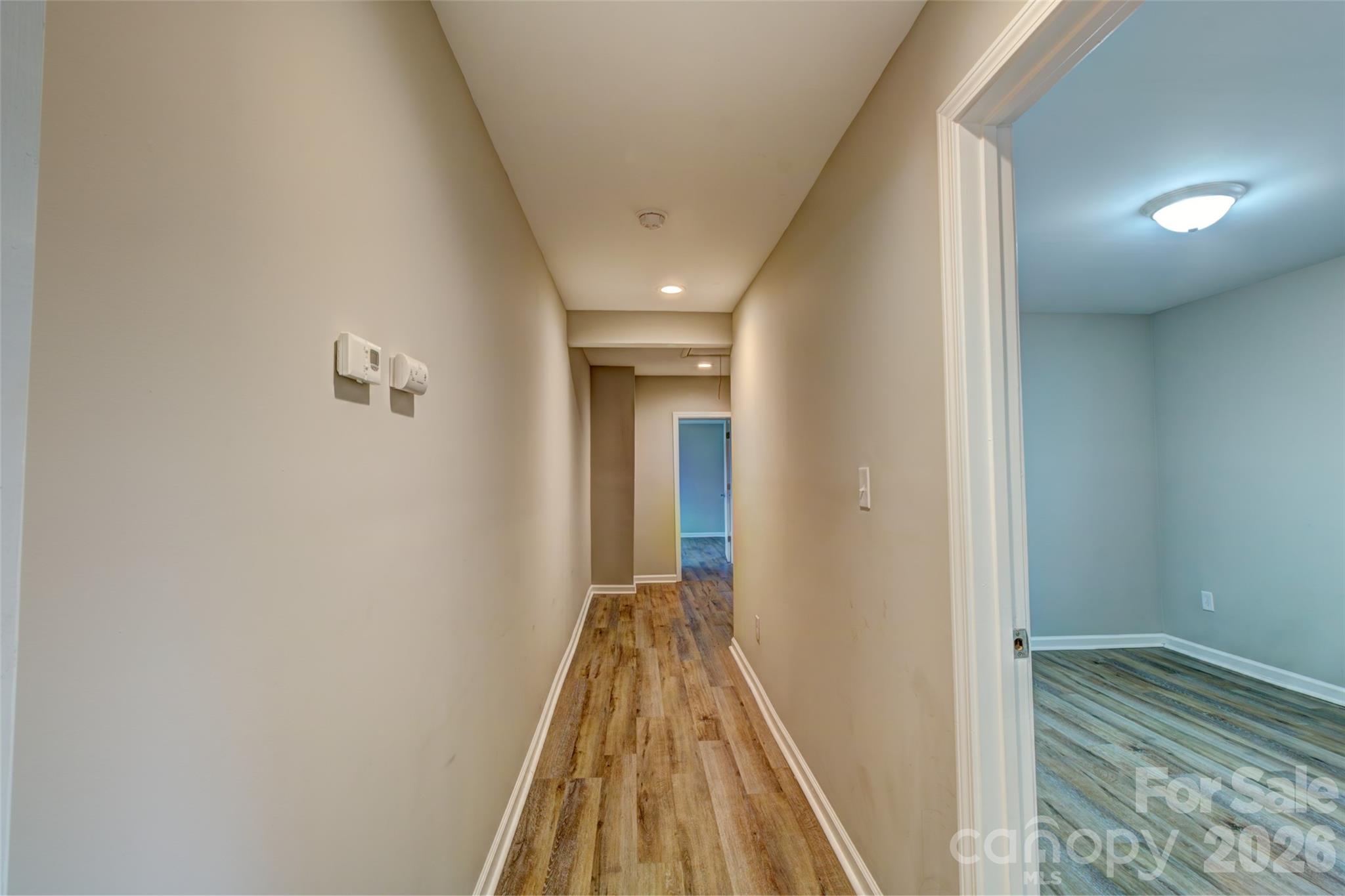 202 Ramsey Street Cherryville, NC 28021 - Photo 8 of 17 a view of a hallway with wooden floor and staircase