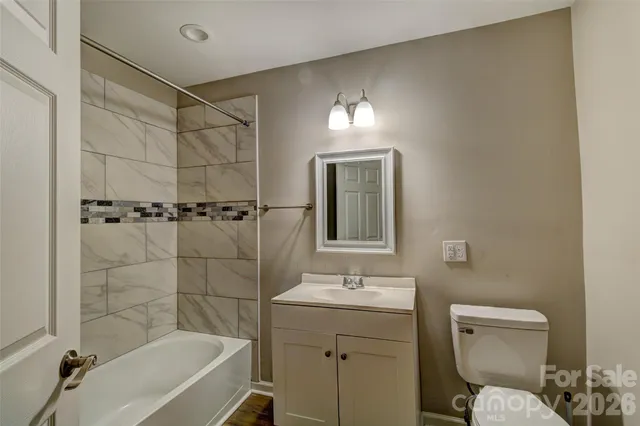 a bathroom with a toilet sink shower and bathtub