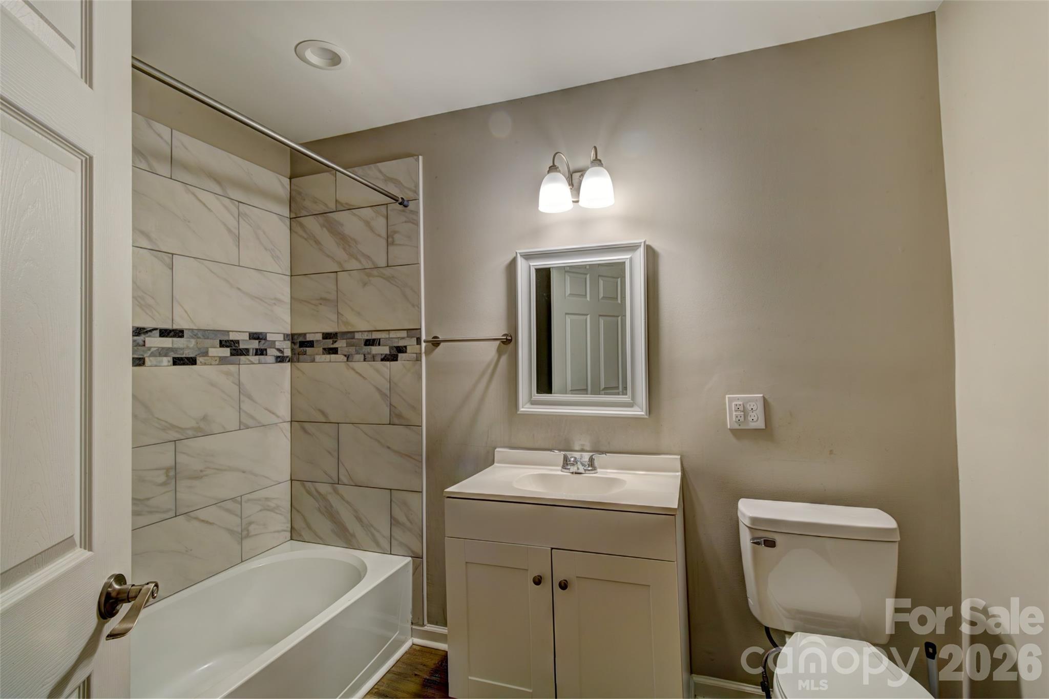 202 Ramsey Street Cherryville, NC 28021 - Photo 10 of 17 a bathroom with a toilet sink shower and bathtub