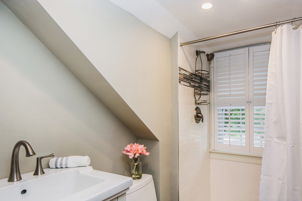 59 Munroe Road Lexington, MA 02421 - Photo 14 of 29 a bathroom with a sink mirror and a shower