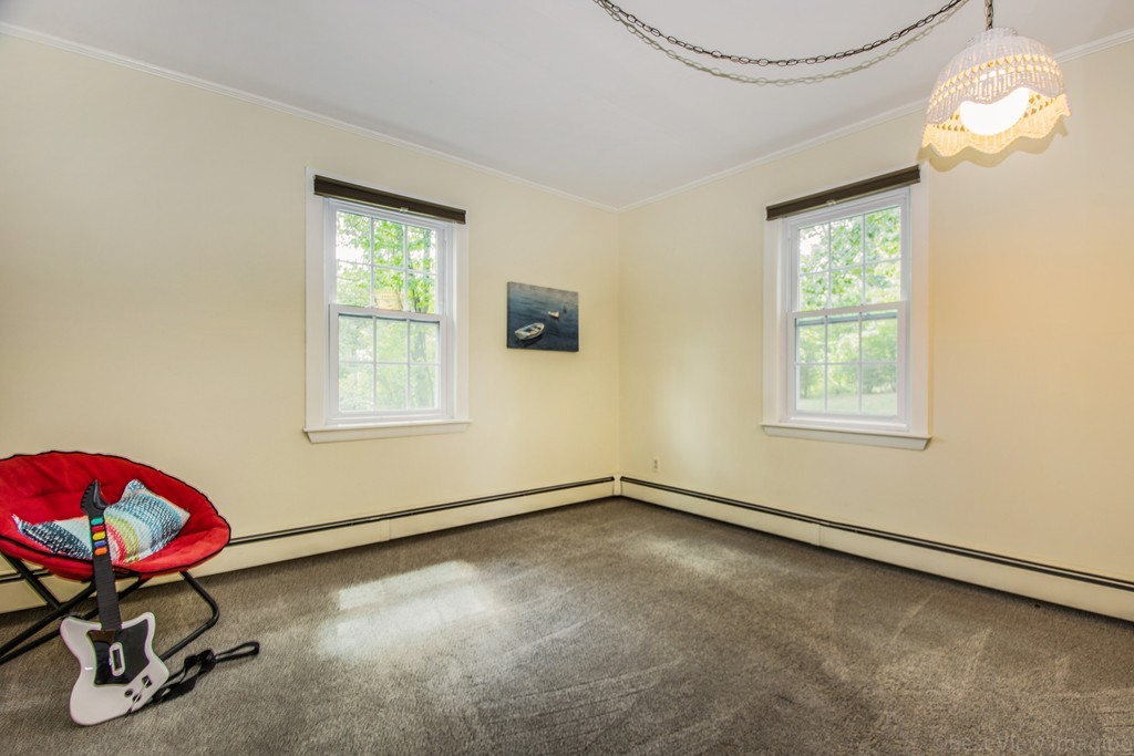 59 Munroe Road Lexington, MA 02421 - Photo 17 of 29 a room with gym equipment and a window