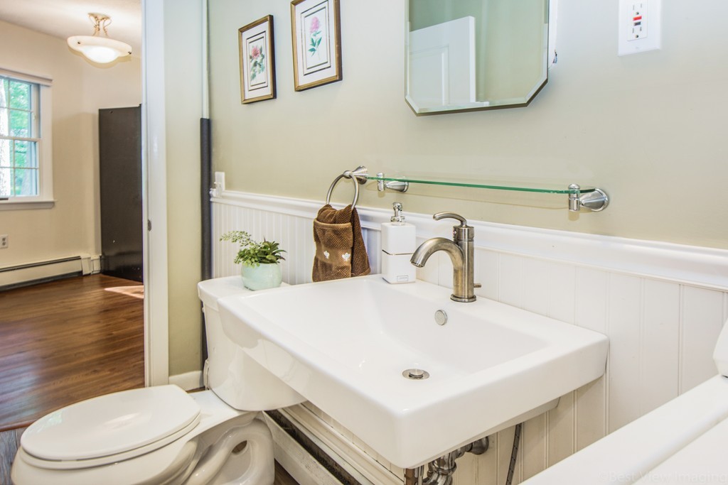 59 Munroe Road Lexington, MA 02421 - Photo 20 of 29 a bathroom with a sink a toilet and mirror
