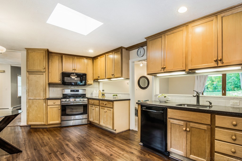 59 Munroe Road Lexington, MA 02421 - Photo 2 of 29 a kitchen with stainless steel appliances granite countertop a stove a sink and a refrigerator