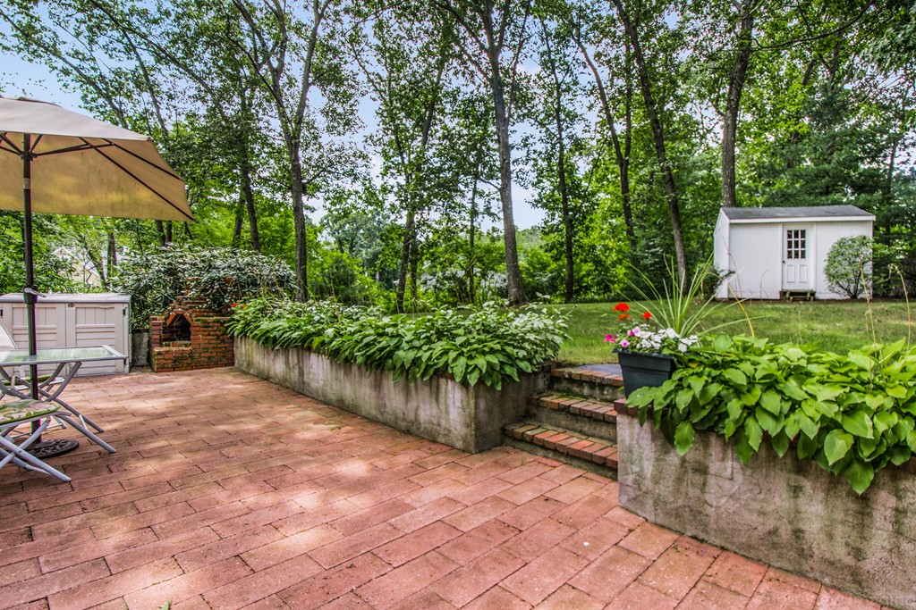 59 Munroe Road Lexington, MA 02421 - Photo 23 of 29 a backyard of a house with a garden and outdoor seating