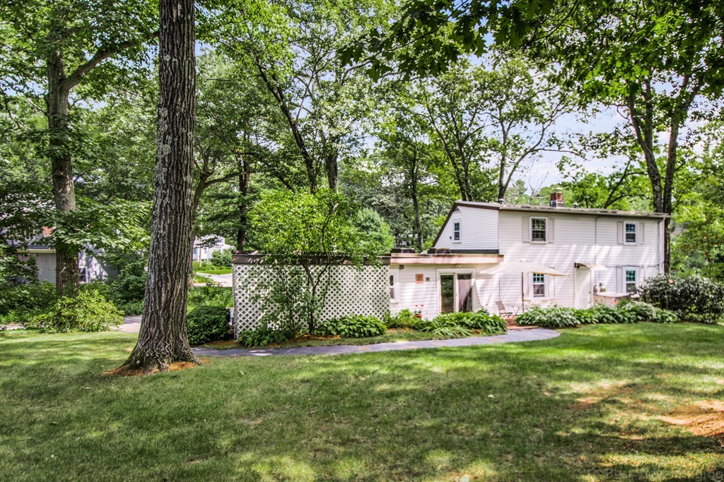 59 Munroe Road Lexington, MA 02421 - Photo 25 of 29 a front view of a house with a yard