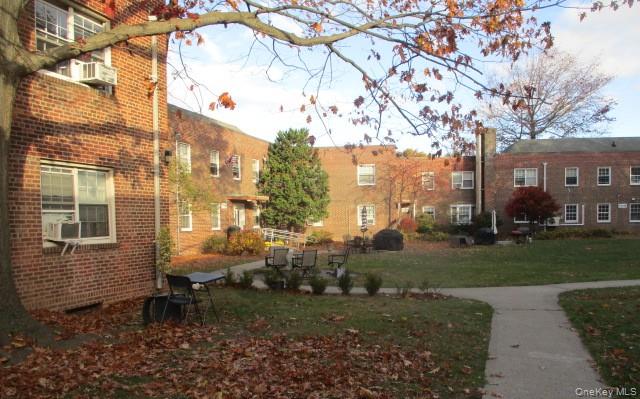 135-12 77th Avenue, Unit 7C Queens, NY 11367 - Photo 1 of 7 a view of a bench in a backyard