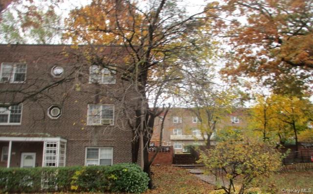 135-12 77th Avenue, Unit 7C Queens, NY 11367 - Photo 2 of 7 a view of a building with a tree