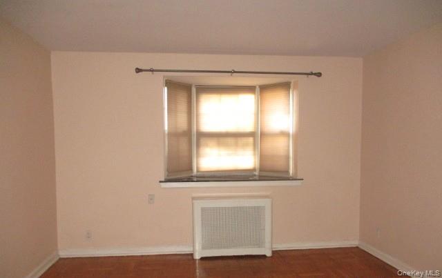 135-12 77th Avenue, Unit 7C Queens, NY 11367 - Photo 3 of 7 a view of an empty room with a window
