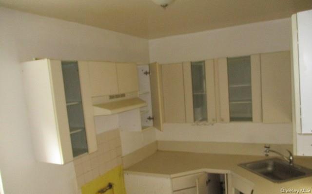 135-12 77th Avenue, Unit 7C Queens, NY 11367 - Photo 4 of 7 a bathroom with a sink a toilet and shower