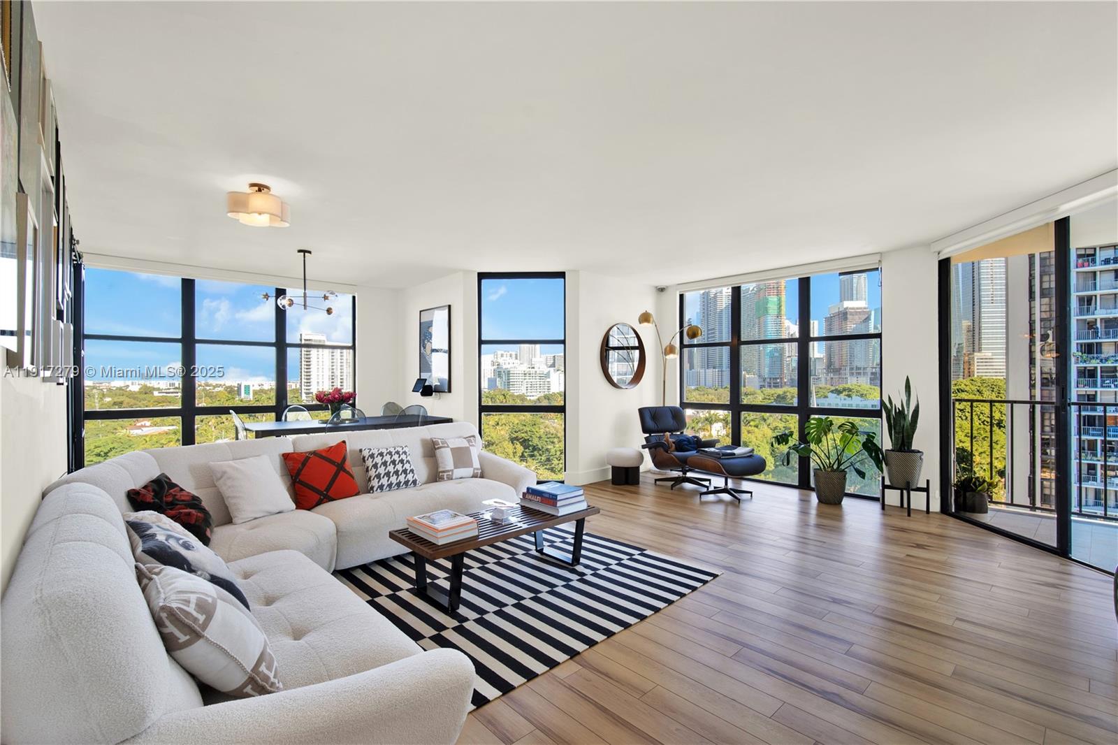 1915 Brickell Avenue, Unit C1101 Miami, FL 33129 - Photo 1 of 55 a living room with furniture floor to ceiling window and wooden floor