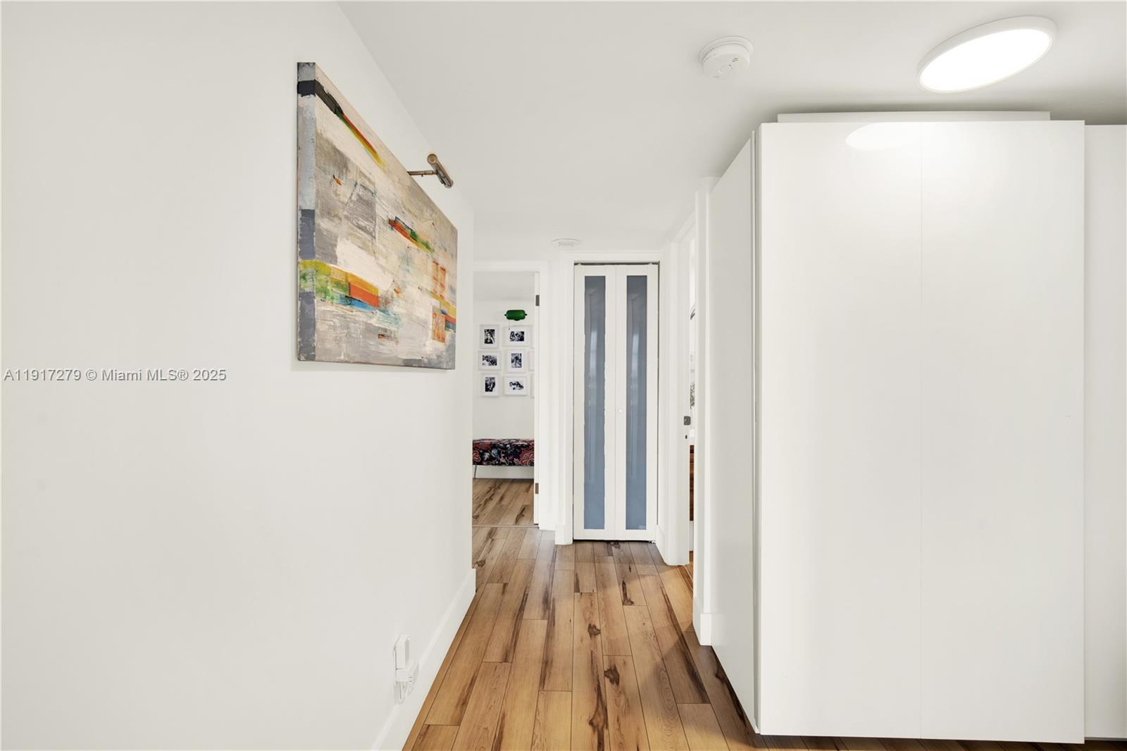 1915 Brickell Avenue, Unit C1101 Miami, FL 33129 - Photo 15 of 55 a view of a hallway with wooden floor and a bathroom