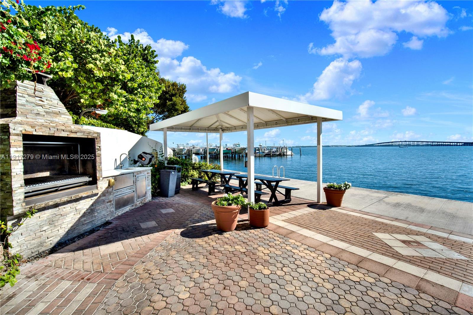 1915 Brickell Avenue, Unit C1101 Miami, FL 33129 - Photo 44 of 55 a view of a patio with a table and chairs under an umbrella