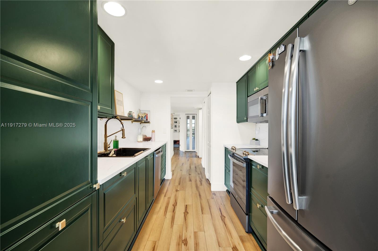 1915 Brickell Avenue, Unit C1101 Miami, FL 33129 - Photo 6 of 55 a kitchen with kitchen island granite countertop lots of counter top space and wooden floor